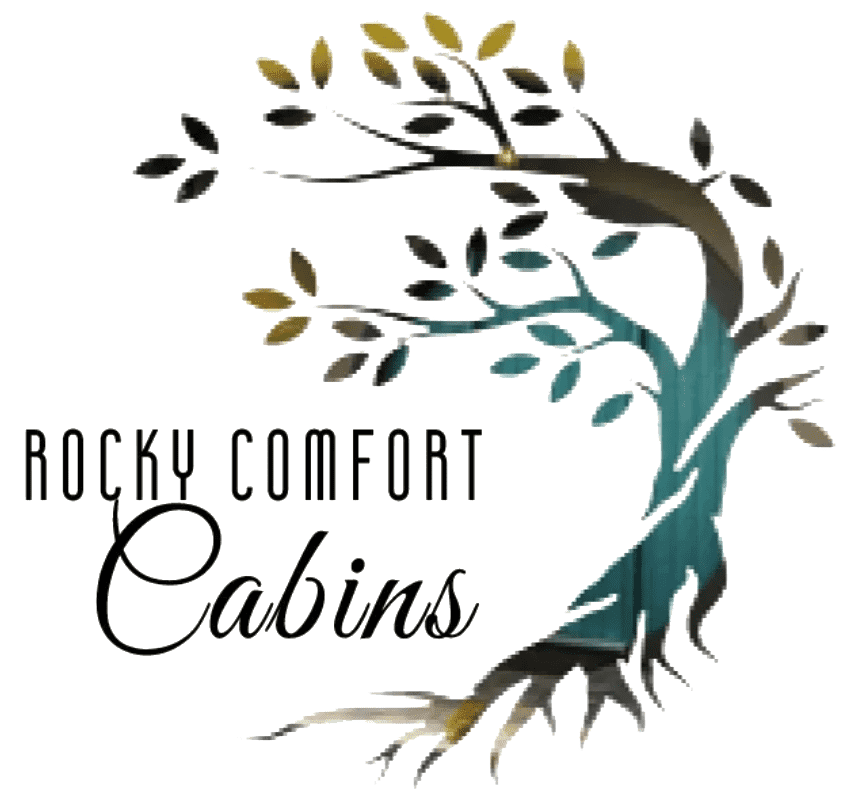 A tree with leaves and the words rocky comfort cabins.