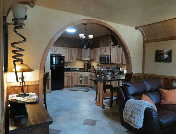 A kitchen with a black refrigerator and a table