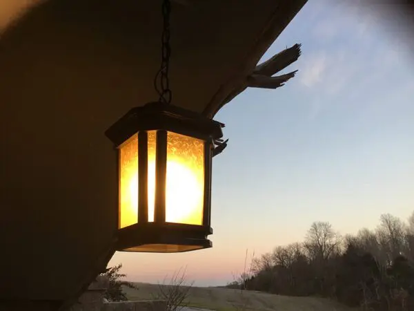 A lamp hanging from the ceiling of a house.