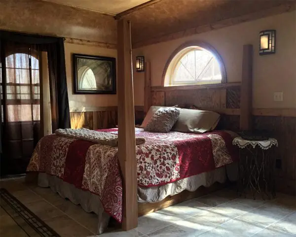 A bed room with a large bed and a window