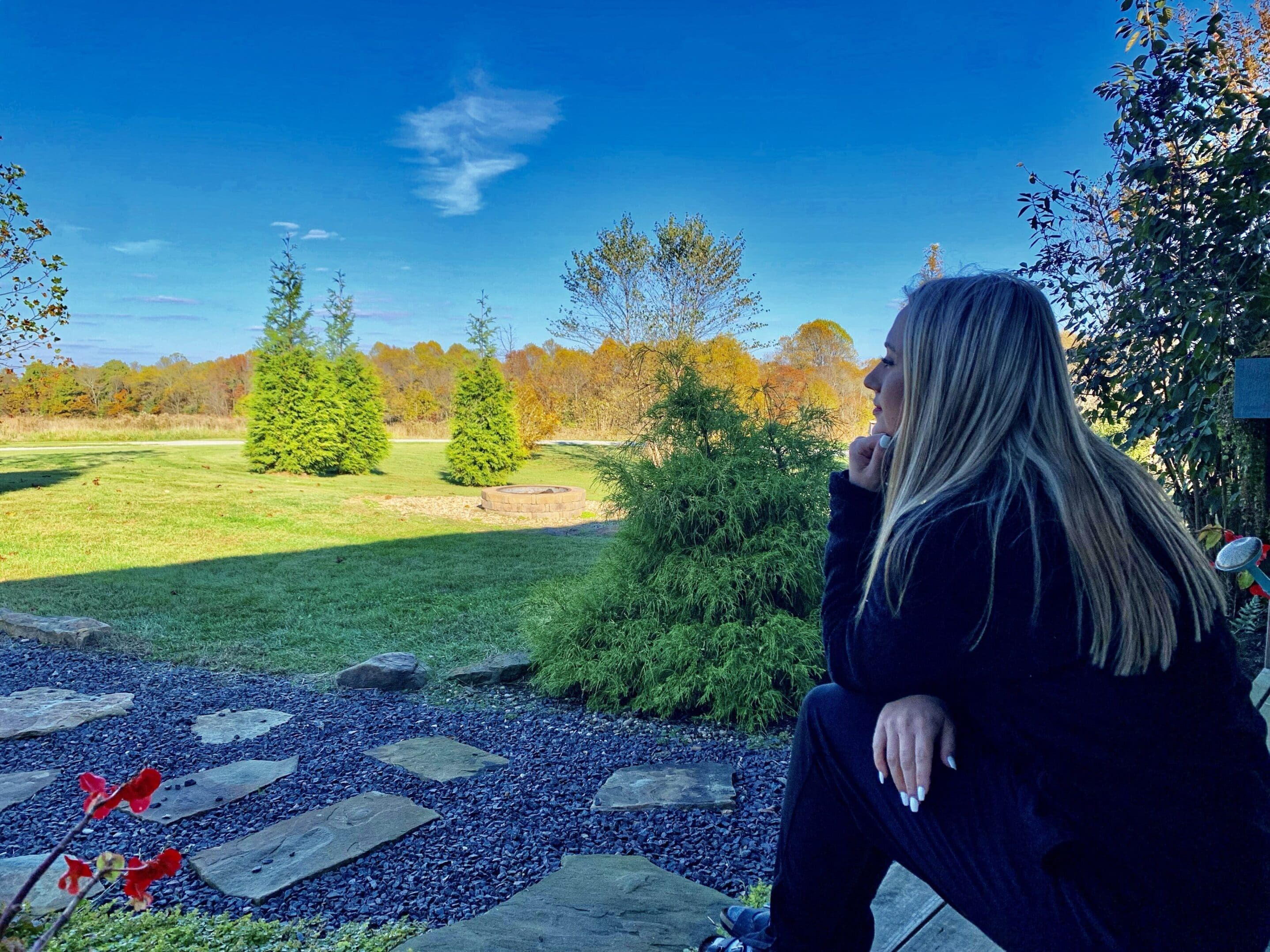 Beautiful girl in serene setting looking out at the fall foliage of the Shawnee Forest from the Creole Cabin