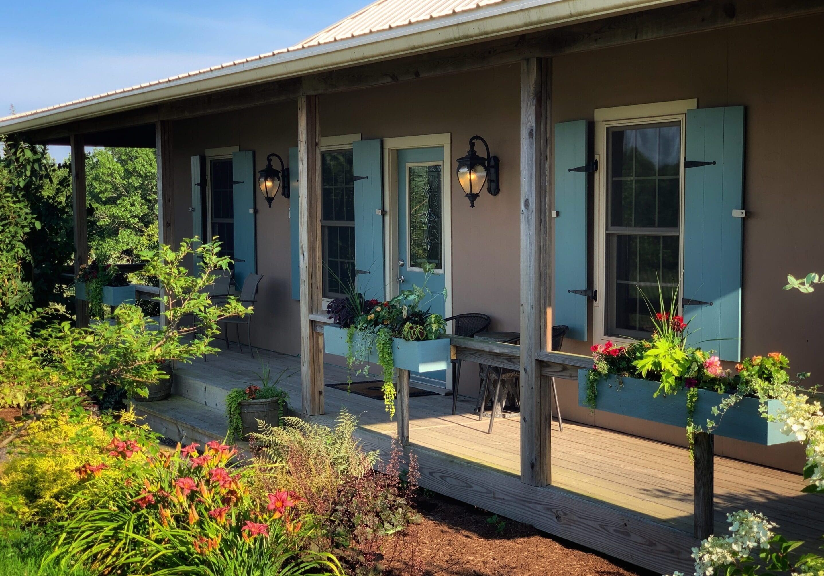 Front porch of Creole Cabin with window boxes full of flowers