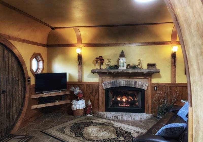 A living room with a fireplace and television.
